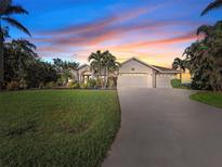 Beautiful home with landscaped yard and three-car garage at 15375 Taurus Cir, Port Charlotte, FL 33981