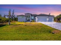 Modern two-story house with gray roof, white walls, and a three-car garage at 15625 Melport Cir, Port Charlotte, FL 33981