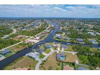Aerial view of waterfront home with private dock and expansive canal views at 9222 Melody Cir, Port Charlotte, FL 33981