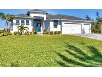 White two-story house with gray roof, landscaping, and two-car garage at 15448 Melport Cir, Port Charlotte, FL 33981