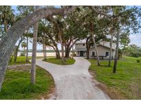 House exterior showcasing a charming home nestled among mature trees at 1990-B Bayshore Dr, Englewood, FL 34223