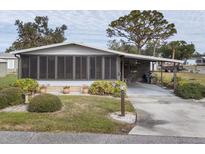 Single-story home with carport and landscaped yard at 735 Summersea Ct, Englewood, FL 34223