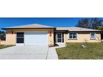 Cute one-story home with attached garage and well-maintained lawn at 13278 Carter Ave, Port Charlotte, FL 33981