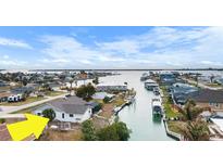 Aerial view of waterfront home with canal access and nearby houses at 1954 Arkansas Ave, Englewood, FL 34224