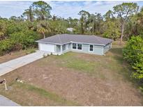 New construction home with a large yard and driveway at 2462 Ensenada Ln, North Port, FL 34286