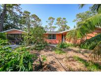 Ranch style home with a fenced yard and mature landscaping at 272 Cedar St, Englewood, FL 34223