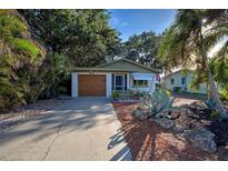 Charming mid-century home with a well-manicured front yard and a two-car garage at 421 Riviera St, Venice, FL 34285