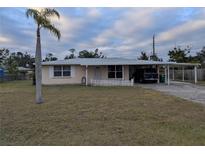 Ranch-style home with carport and spacious yard at 839 E 4Th St, Englewood, FL 34223