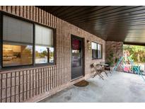 Inviting porch with seating and a partial kitchen view at 9000 Griggs Rd # G, Englewood, FL 34224