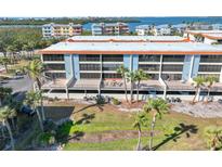 Aerial view of condo building showcasing water views and private balconies at 1551 Beach Rd # 205, Englewood, FL 34223