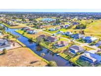 Aerial view of a single-Gathering home with a canal and golf course nearby at 197 Bunker Rd, Rotonda West, FL 33947
