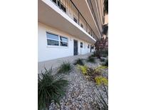 Exterior view of condo building showcasing landscaping and building features at 244 Saint Augustine Ave # 102, Venice, FL 34285