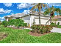 Single-story home with attached garage, landscaping, and a paved driveway at 3283 Osprey Ln, Port Charlotte, FL 33953