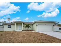 Newly built home with a two-car garage and manicured lawn at 5353 Kaspar St, Port Charlotte, FL 33981