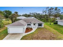 Newly constructed home with a two-car garage and landscaped front yard at 5400 Jennings Blvd, Port Charlotte, FL 33981