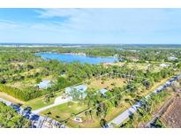 Aerial view of property showcasing house, large lot, and lake at 9000 Falcon Ct, Venice, FL 34293