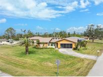 Single-story home with spacious lawn and driveway, situated in a residential neighborhood at 9822 Gulfstream Blvd, Englewood, FL 34224