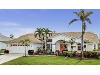 Lovely single-Gathering home with a well-manicured lawn, beautiful tropical landscaping and a welcoming entryway at 15361 Visalia Rd, Port Charlotte, FL 33981