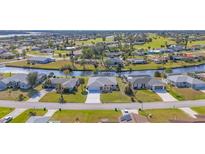 Aerial view of a canal-front home in a residential community at 162 Annapolis Ln, Rotonda West, FL 33947