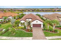 Luxury home with landscaped yard and lake view in a desirable community at 26837 Weiskopf Dr, Englewood, FL 34223