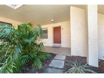 Condo exterior walkway with tropical landscaping at 66 Boundary Blvd # 280, Rotonda West, FL 33947