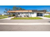 Single-story home with carport and landscaped yard at 672 Circlewood Dr # V9, Venice, FL 34293