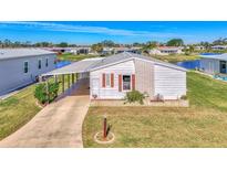 Single-story home with carport and landscaped lawn at 812 Seabrooke Dr, Englewood, FL 34223