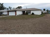 Single-story home with attached garage and spacious yard at 914 E 2Nd St, Englewood, FL 34223