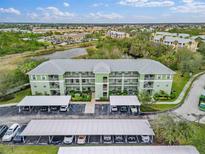 Aerial view of a community with building, parking, and landscaping at 2121 Heron Lake Dr # 301, Punta Gorda, FL 33983