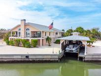 Waterfront home with boat lift and private dock, offering stunning canal and ocean views at 2805 N Beach Rd # B, Englewood, FL 34223