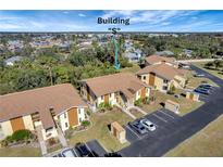 Aerial view of condo building and surrounding landscape at 6699 San Casa Dr # S1, Englewood, FL 34224