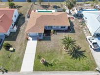 Aerial view of single-Gathering home with pool and landscaped yard at 93 Rotonda Cir, Rotonda West, FL 33947