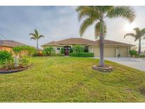 Beautiful one-story home with a three-car garage and lush landscaping at 1 Sportsman Ter, Rotonda West, FL 33947