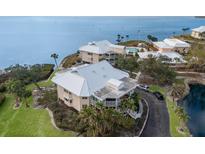 Aerial view of waterfront property with a private driveway and lush landscaping at 11000 Placida Rd # 201, Placida, FL 33946