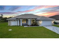 Single-story home with attached garage and landscaped yard at 14291 Ingraham Blvd, Port Charlotte, FL 33981