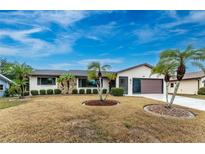 Single-story home with palm trees and a well-maintained lawn at 1505 Fireside St, Port Charlotte, FL 33952