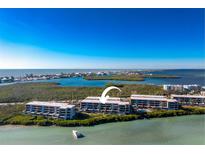 Stunning aerial view of coastal condos with waterfront access and serene turquoise waters at 1701 Beach Rd # 404, Englewood, FL 34223