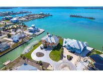 Aerial view of waterfront home with private dock and circular driveway at 1901 Illinois Ave, Englewood, FL 34224