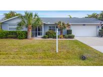 Charming single story home with a well-manicured lawn and attached garage at 5292 Early Ter, Port Charlotte, FL 33981