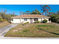 Charming single-story home with a well-maintained lawn and inviting curb appeal at 7522 Sea Mist Dr, Port Charlotte, FL 33981