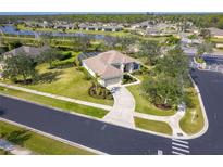 Aerial view of single-story house with pool and landscaped yard in a residential community at 12650 Montigello Ct, Englewood, FL 34223