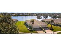 Single Gathering home with lake view and lush landscaping at 13489 Abercrombie Dr, Englewood, FL 34223