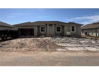 New construction home exterior, featuring a single-story design and a two-car garage at 14149 Whittier Ln, Port Charlotte, FL 33981