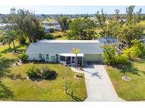 Single-story home with a screened patio and pool, in a peaceful community at 142 Caddy Rd, Rotonda West, FL 33947