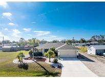 Aerial view of single-story home with landscaped yard and driveway at 1521 Saint Clair Rd, Englewood, FL 34223