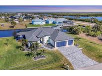 Spacious waterfront home with a large backyard and two-car garage at 15410 Seafoam Cir, Port Charlotte, FL 33981