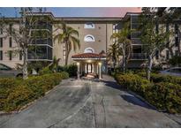 Inviting condo building entrance with lush landscaping at 25188 Marion Ave # C206, Punta Gorda, FL 33950