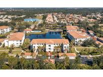 Aerial view of condo community with lake, pool, and lush landscaping at 300 San Lino Cir # 322, Venice, FL 34292