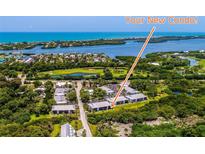 Beautiful aerial view of coastal community, golf course, and tranquil waters at 6800 Placida Rd # 122, Englewood, FL 34224