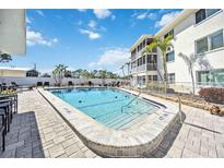 Inviting community pool with ample deck space for lounging at 708 Tamiami S Trl # 103, Venice, FL 34285